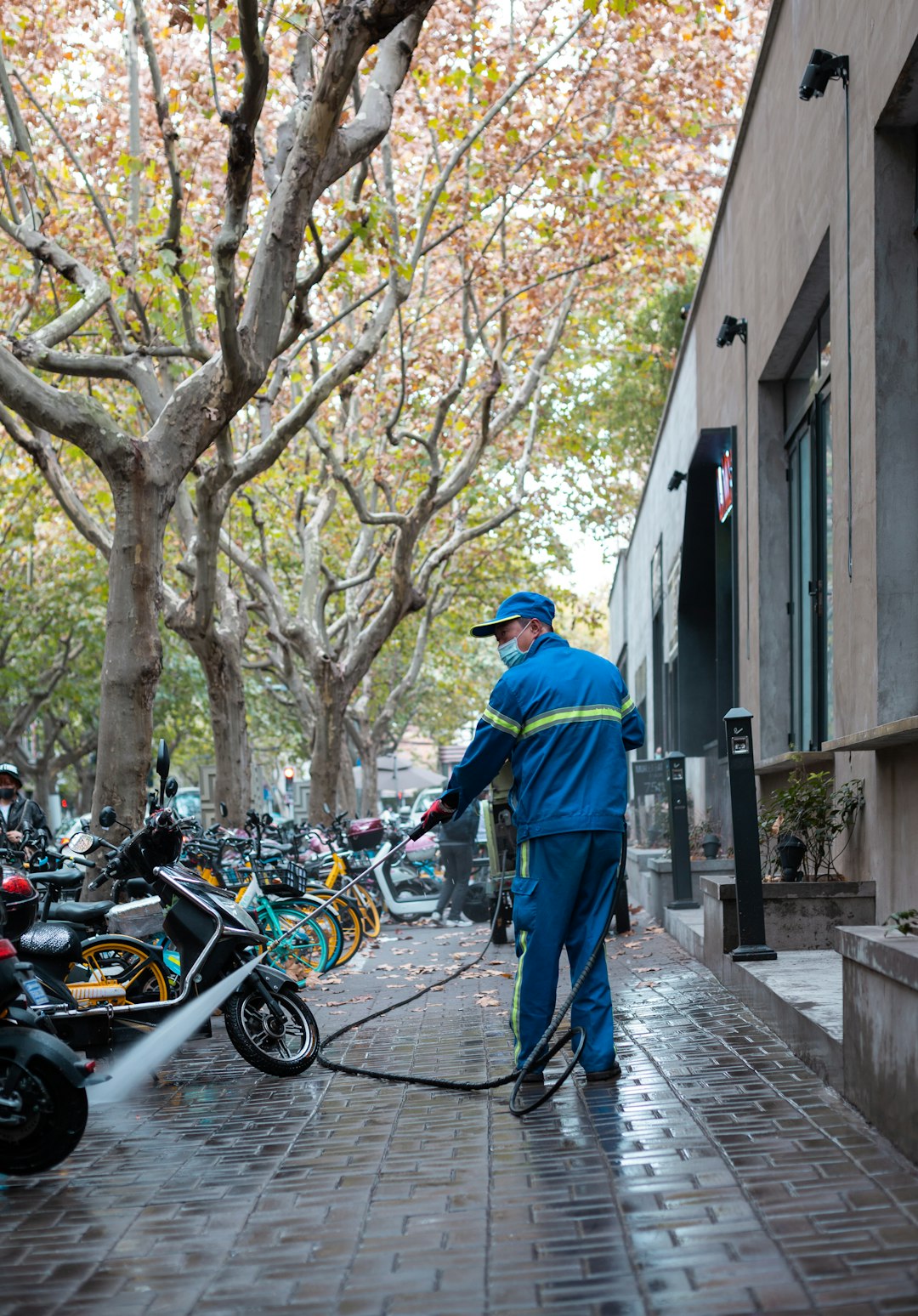 A worker cleans the sidewalk in Shanghai